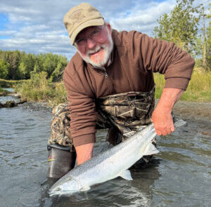 A client of RiverRise Fishing Guides with a trophy Rainbow that he caught on a guided fishing trip