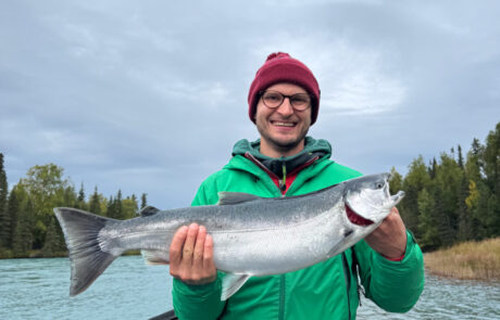 A RiverRise Fishing Guides client with a Silver Salmon from a recent fishing trip