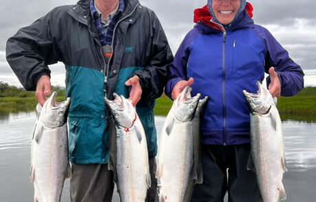 fishing clients on the kenai river holding a limit of silver salmon