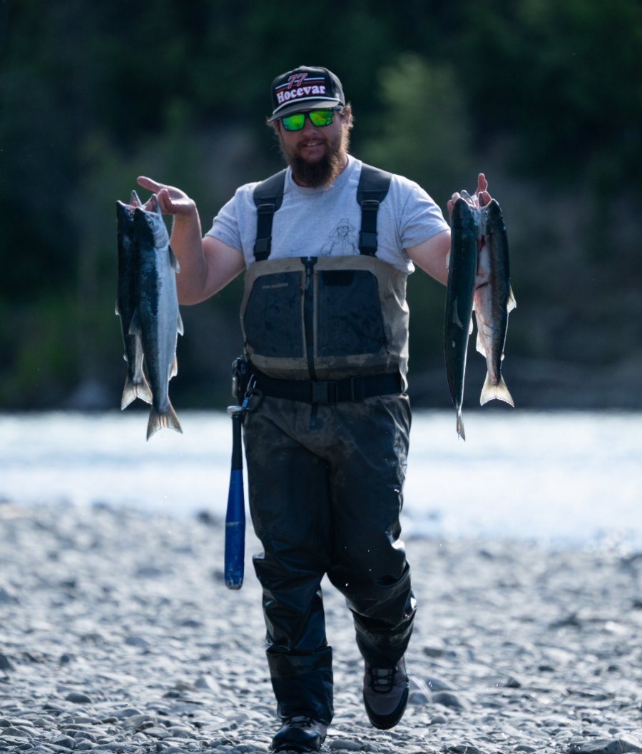 Captain Rob Captain Rob of RiverRise Fishing Guides holding sockeye salmon on a Kenai River gravel bar